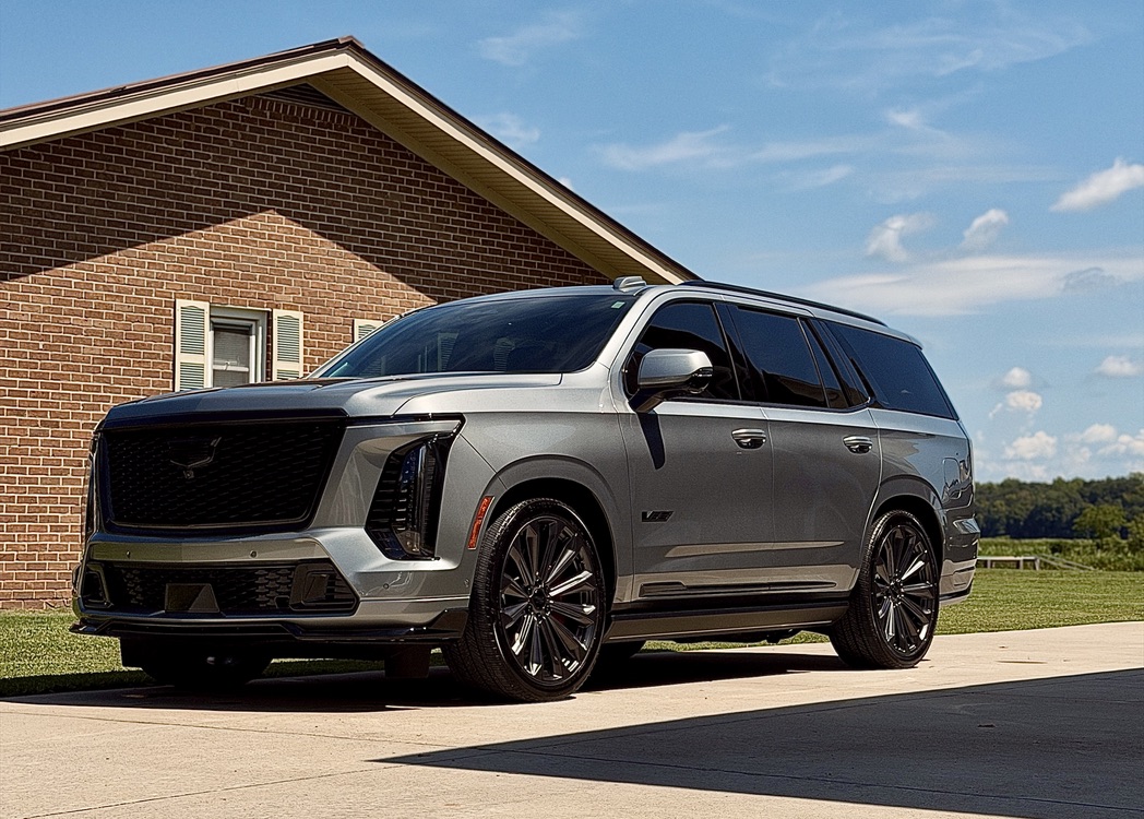 Silver Cadillac SUV in a driveway